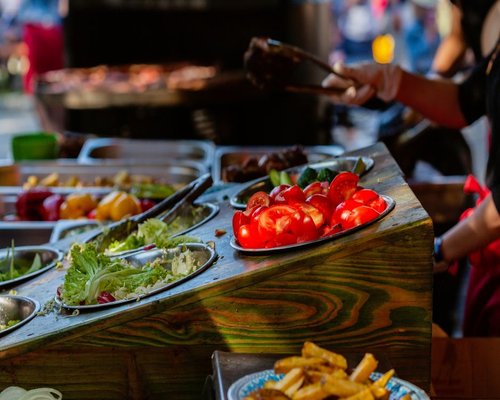 A beautiful selection of fresh colorful tomatoes, green salads and local fish at a traditional Chilean open market